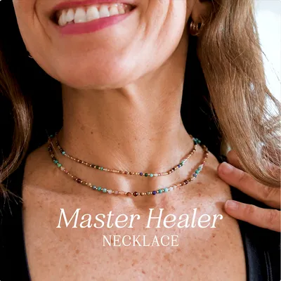 An artisan in Thailand threading the beads of a Master Healer necklace